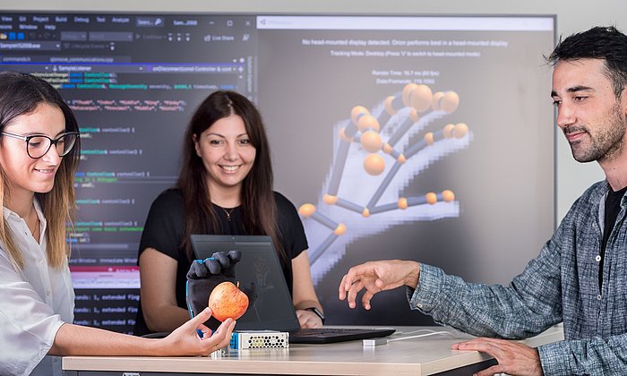 Researcher with a robot hand