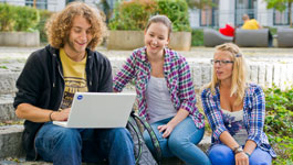 Students with a laptop on campus. Students with a laptop on campus
