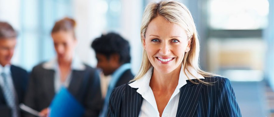 Smiling woman wearing business-clothes.