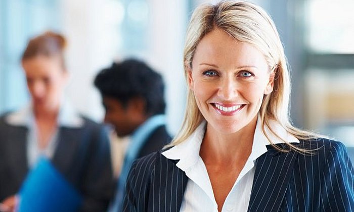 Smiling woman wearing business-clothes.