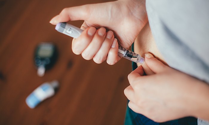 Eine Frau bei der Injektion mit einem Insulinpen
