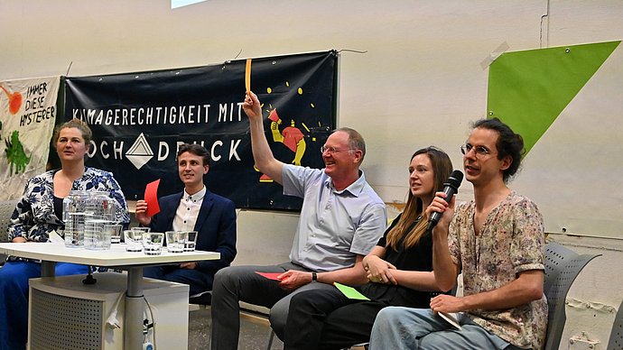 Elias Singer, Werner Lang, Lucia Layritz, and the moderation team at the fishbowl discussion on the role of universities in climate crisis.