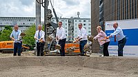 The speakers break ground for the building.