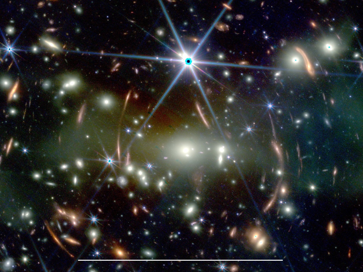 This JWST image shows the galaxy cluster SMACS J0723.3−7327 with a large number of lensed background galaxies. The white bar at the bottom corresponds to 50 arcsec, which is approximately the maximum size of Jupiter observed from Earth.