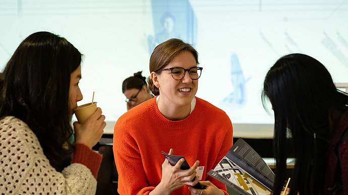 Three female participants have an animated conversation at the TUM4Mind Action Day 2018.