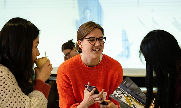 Three female participants have an animated conversation at the TUM4Mind Action Day 2018.