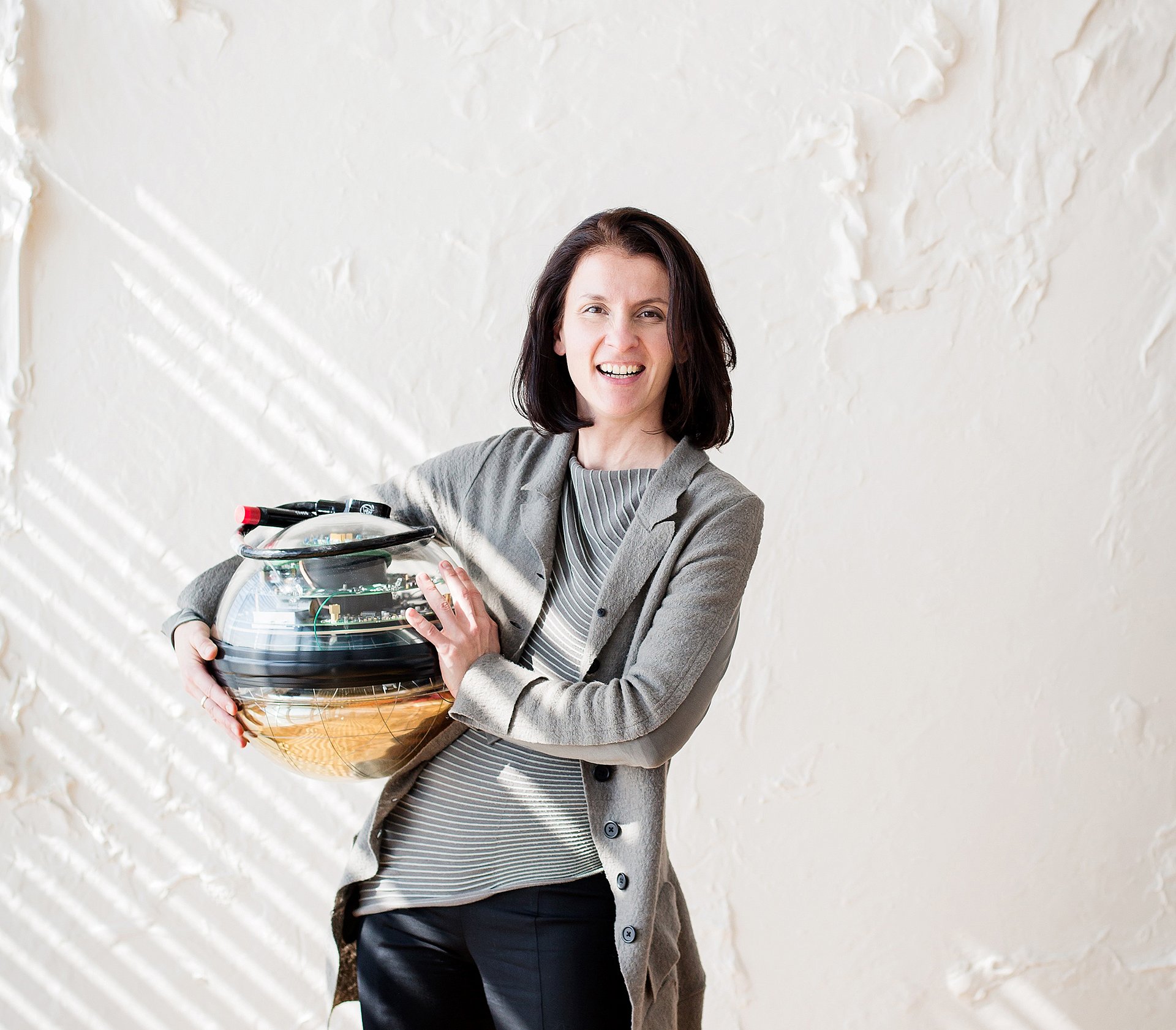 Prof. Elisa Resconi with one of the photo-detectors used in the IceCube observatory. (Picture: Magdalena Jooß / TUM)