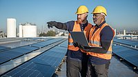 Two engineers inspect a photovoltaic system.