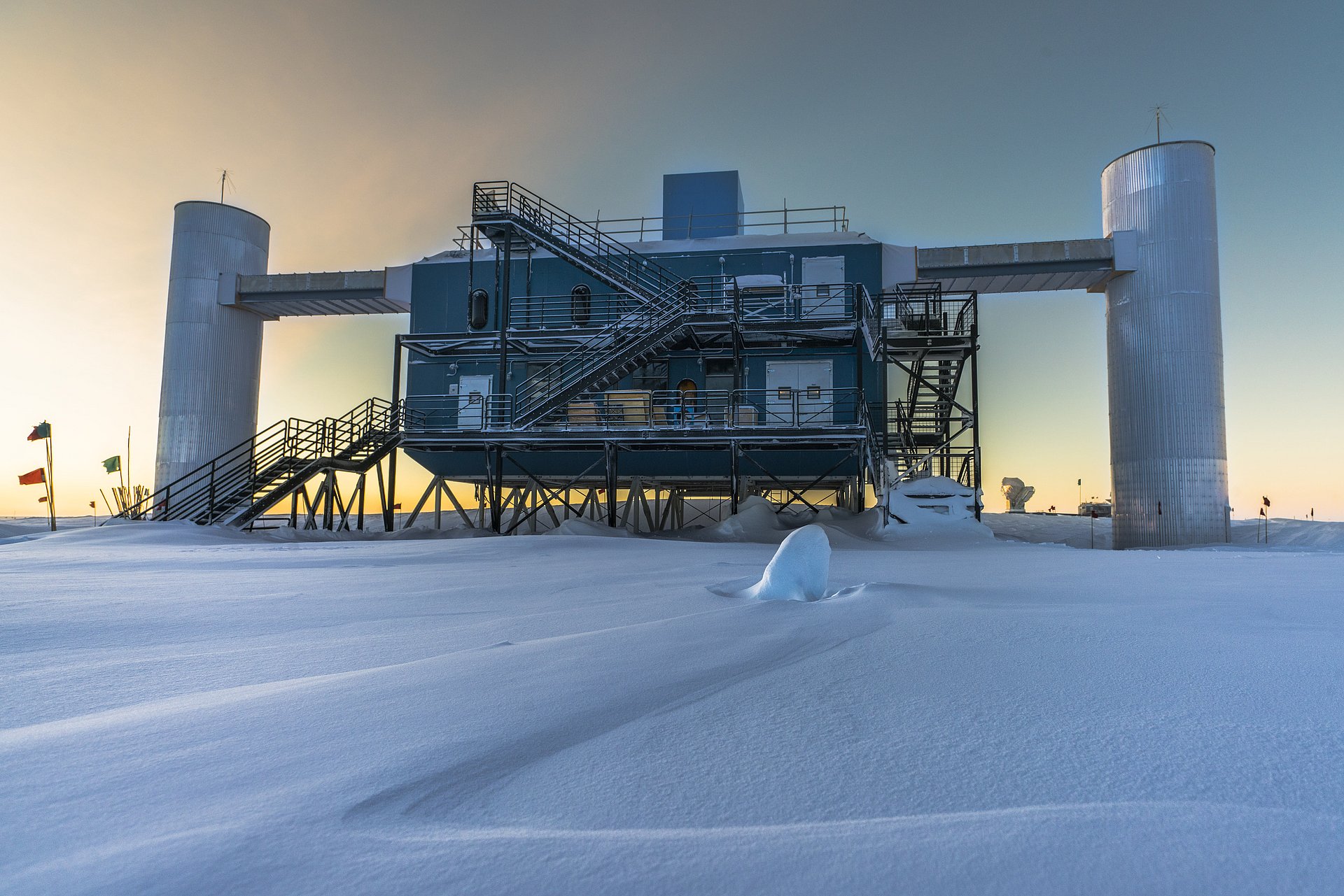 The IceCube detector seen against the setting sun.