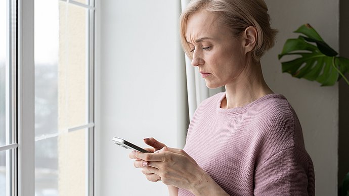 Eine Frau schaut auf ein Smartphone