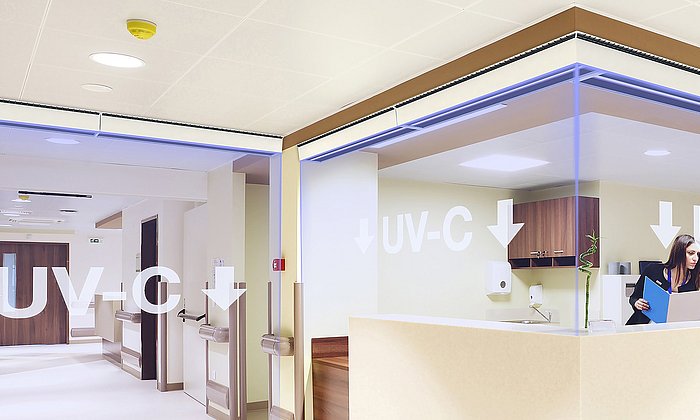 UV-C light extricates aerosols from pathogens such as the SARS-CoV-2 virus. This creates an invisible virus protection wall that protects the people behind it without restricting people's freedom of movement. An automatic shut-off device protects people passing through from UV radiation.