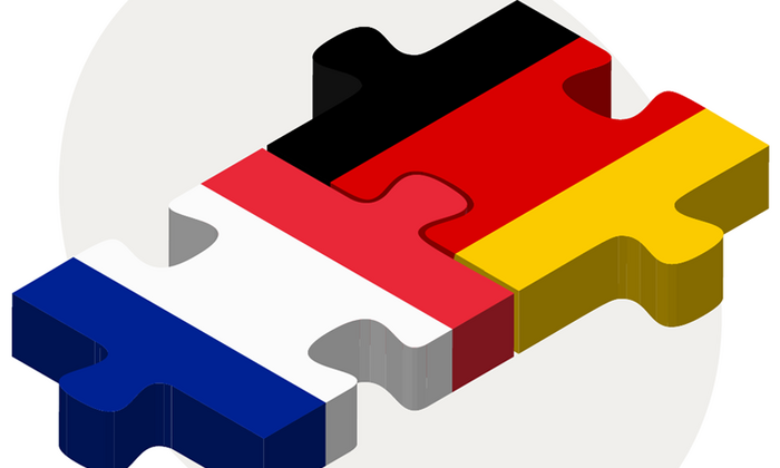 Die deutsche und die französische Flagge als Puzzleteile, die ineinandergreifen.