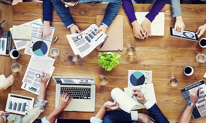 Employees of a company discussing at a table