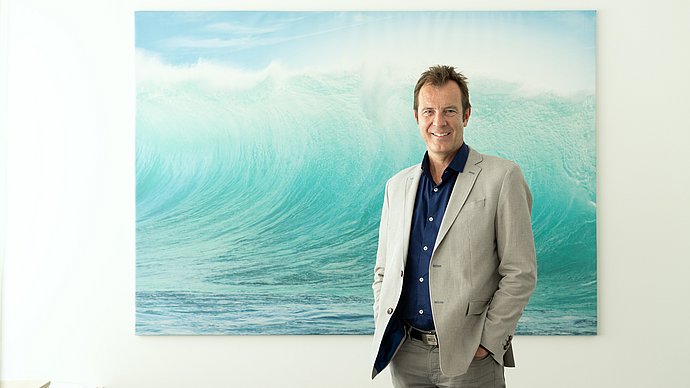 Portraitaufnahmen von Prof. Dr.-Ing. Joerg E. Drewes vor einem Bild