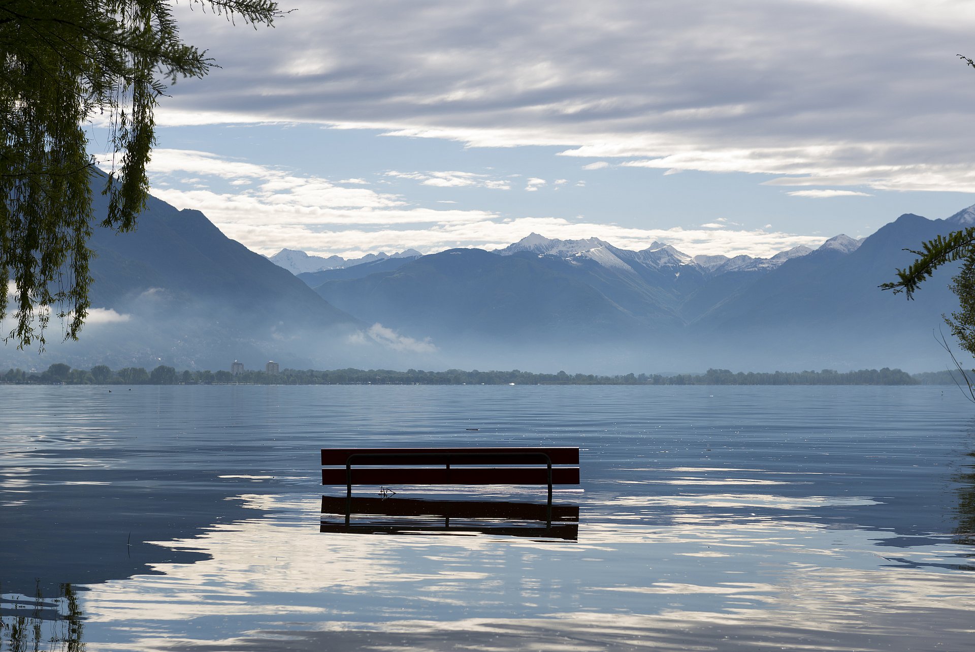 A bench in a flooded area.