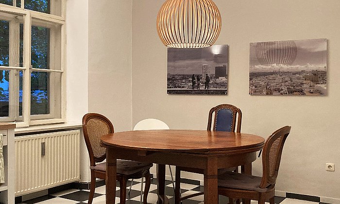 A kitchen in a student shared flat, in the center a table with four chairs