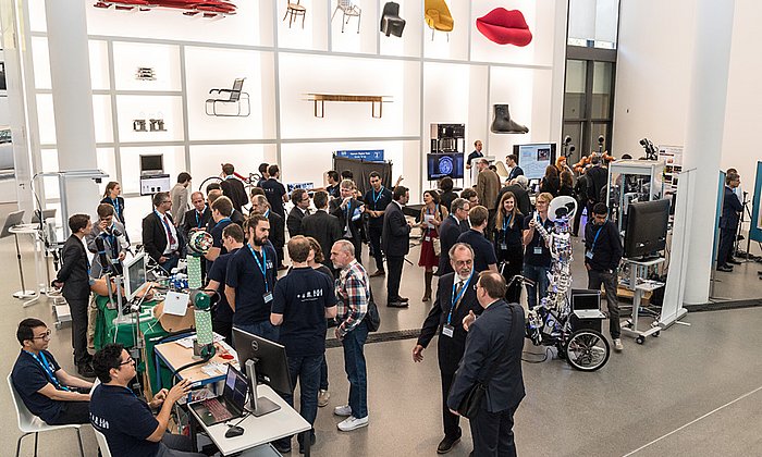 Science projects among design object: Several of TUM's robotics research groups presented their projects at Pinakothek der Moderne. (image: U. Benz / TUM)