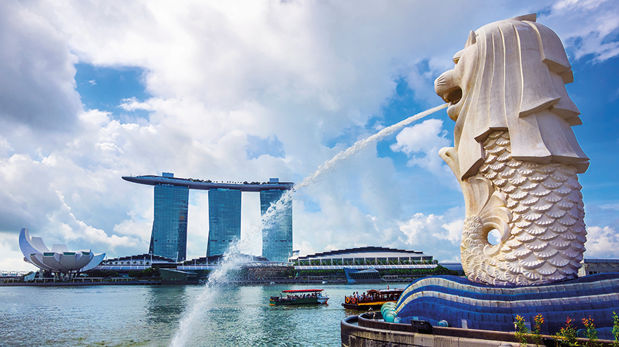 View of Merlion statue, symbol of Singapore, with famous Marina Bay Sands hotel in the background.