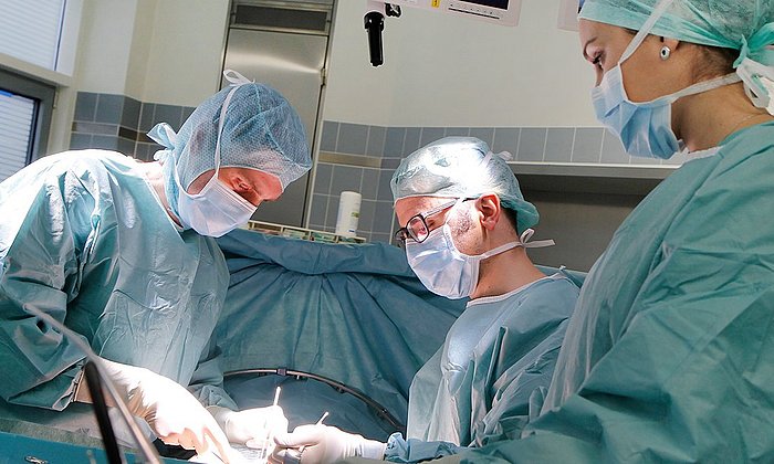 Medical doctors operating on a surgery.