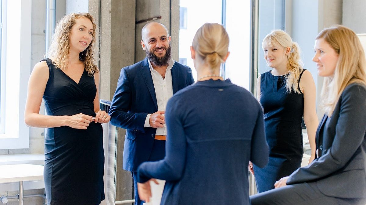 Group of people in business attire chatting
