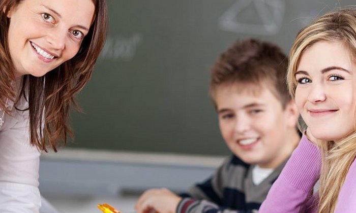 Teacher with two school students