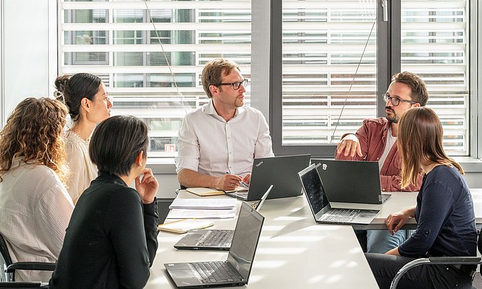 Prof. Michael Laxy (center) and his team, including Karl Emmert-Fees