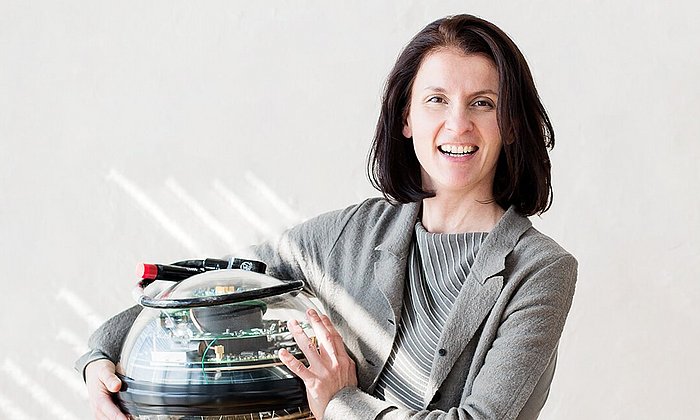 Physicist Prof. Elisa Resconi holds a sensor from the neutrino observatory IceCube.