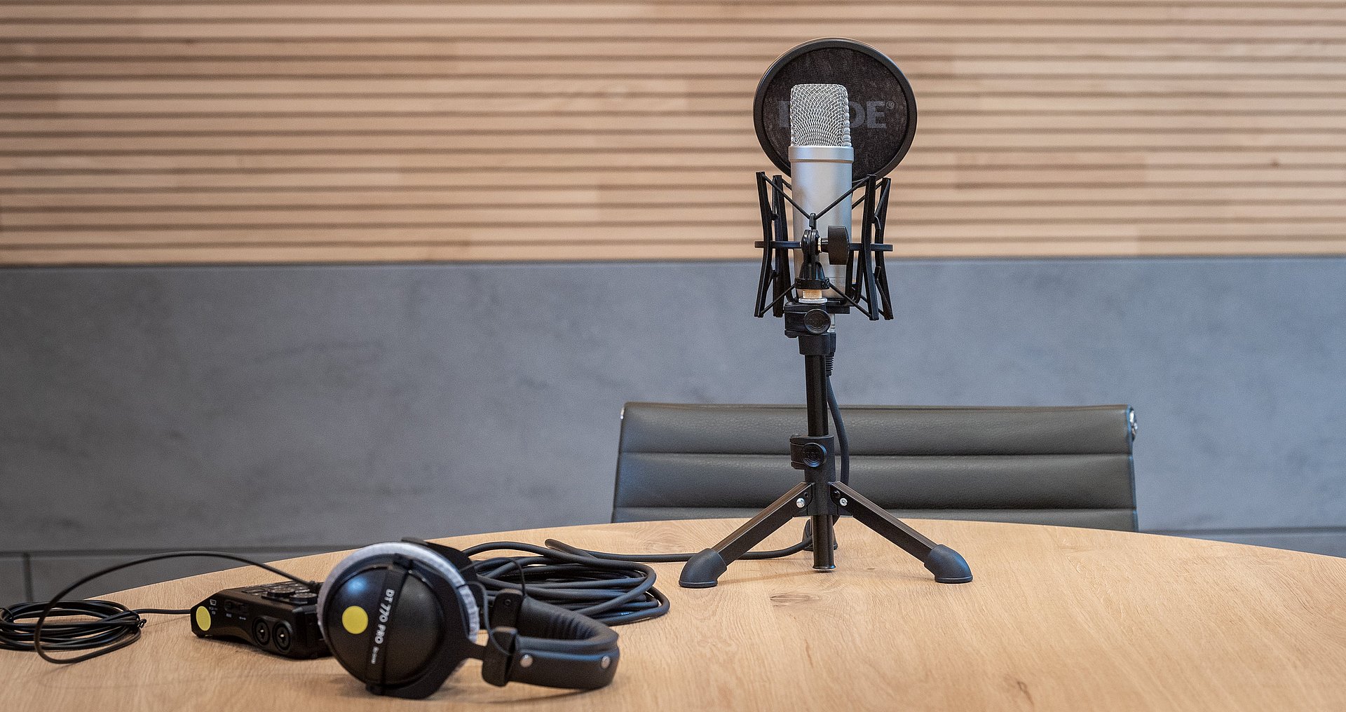 Recording equipment on a table, including a large microphone