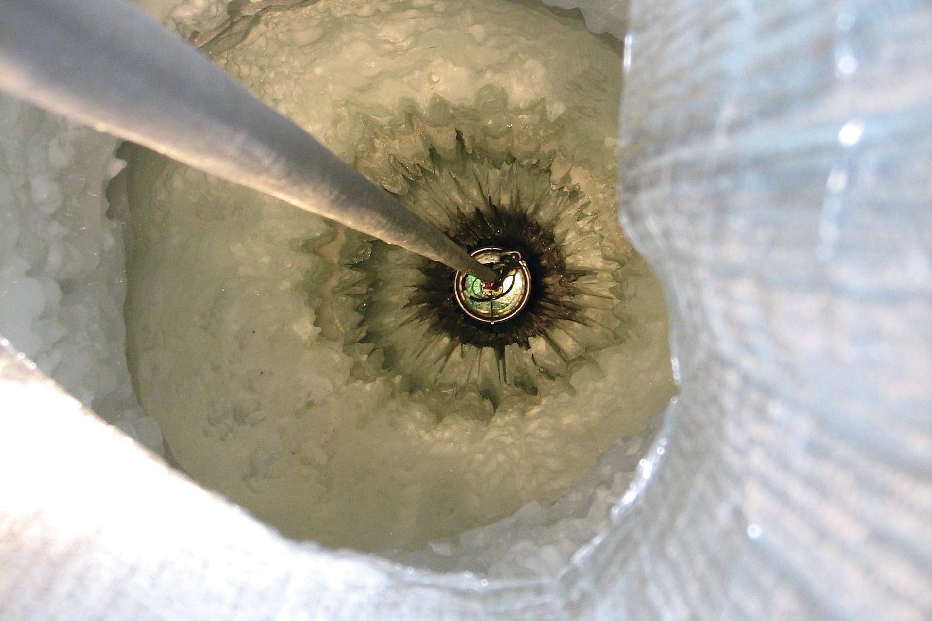 Digital optical module being lowered into the ice.