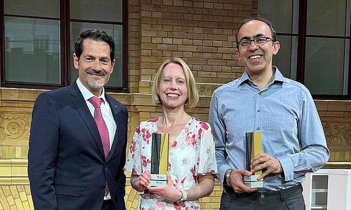 TUM President Thomas Hofmann with Stefanie Jegelka and Suvrit Sra