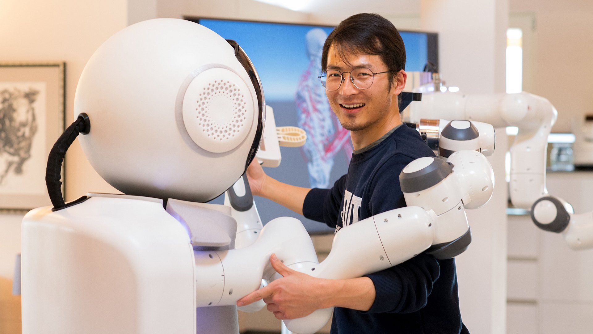 GARMI, a robot assistant for the elderly, together with an employee of Munich Institute of Robotics and Machine Intelligence.