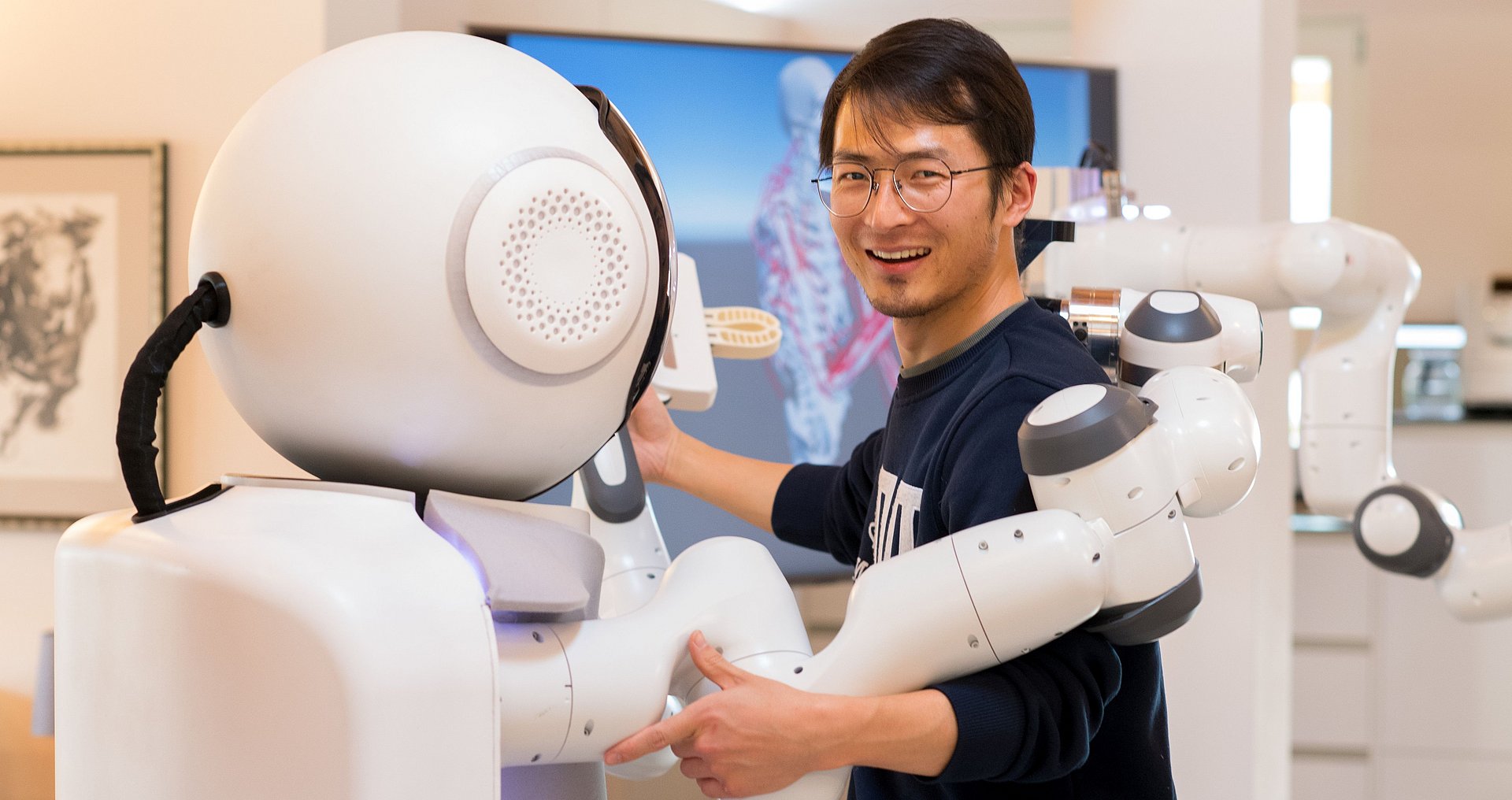 GARMI, a robot assistant for the elderly, together with an employee of Munich Institute of Robotics and Machine Intelligence.