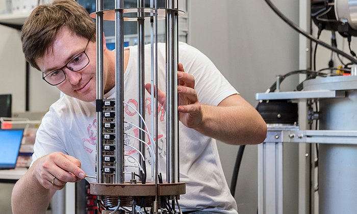 Andreas Wendl preparing a superconducting magnet system.