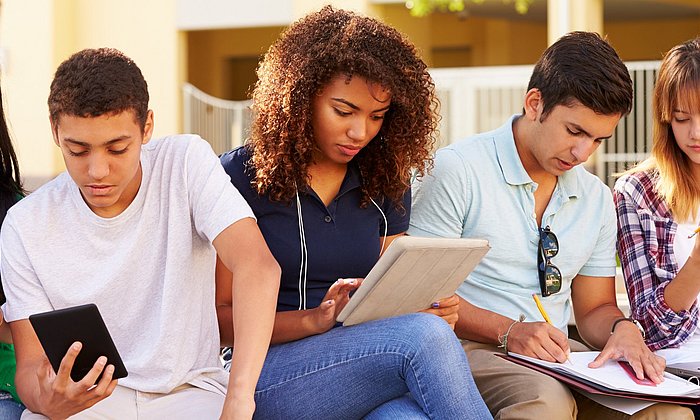 Young people with tablet computers and smartphones