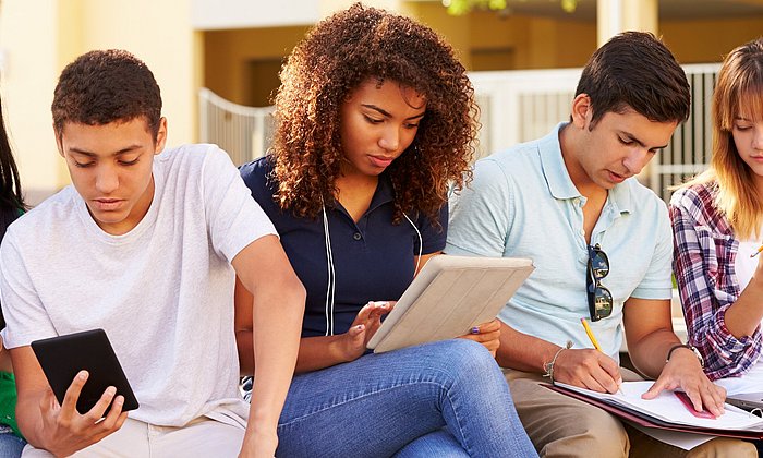 Male and female students are reading.