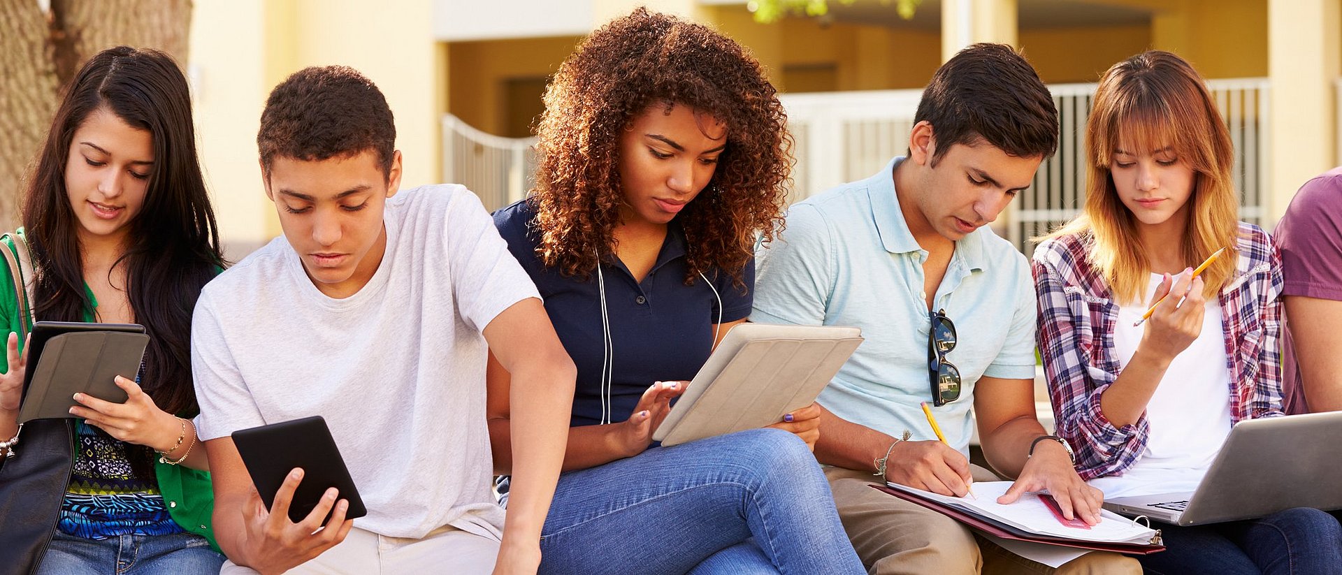 Young people with tablet computers and smartphones