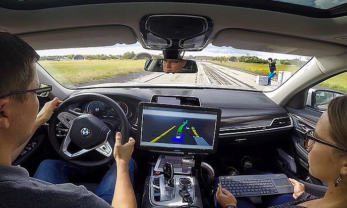 An autonomous vehicle avoiding a pedestrian dummy.