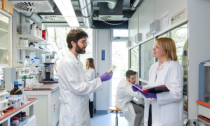 Group Leader in Chemical Proteomics, Dr. Guillaume Médard, and his research group in the lab.