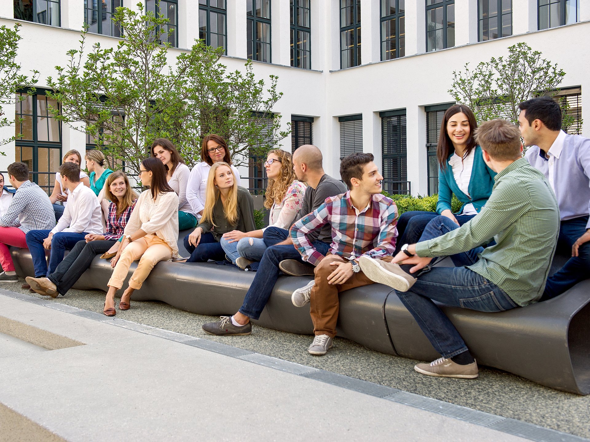 Students chatting in the courtyard of TUM's city center branch.