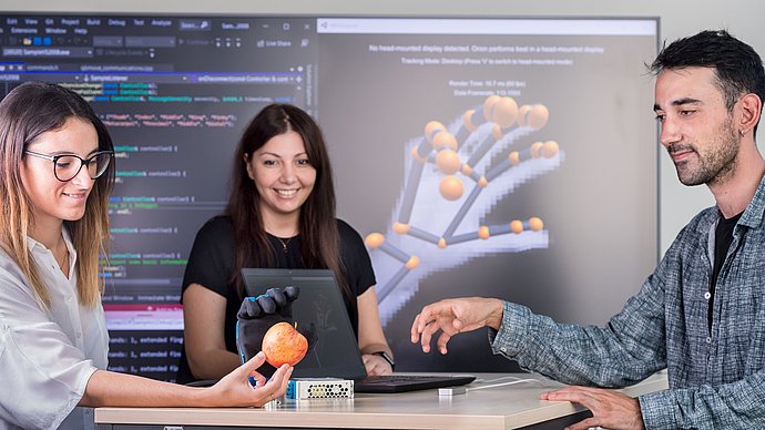 Researcher with a robot hand
