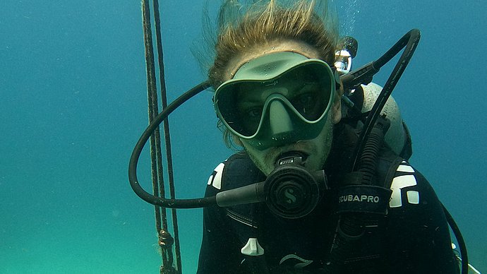 Christopher Chvalina in diving gear under water 