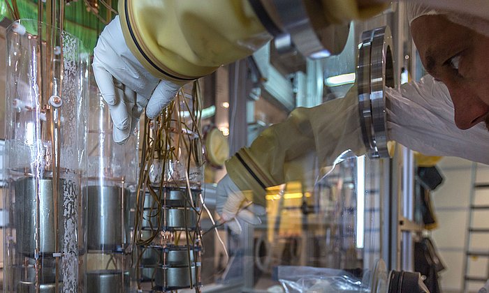 A scientist works on the germanium detector array in the clean room of Gran Sasso underground laboratory.