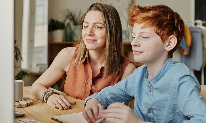 Woman and boy doing school homework