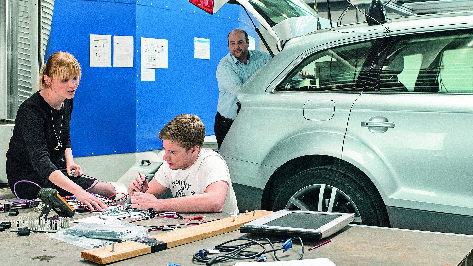 Research team working in a mechanical engineering lab.