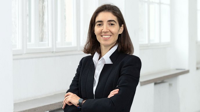 Photo of Prof. Dr. Chiara Manfletti in a black jacket in front of a white window front