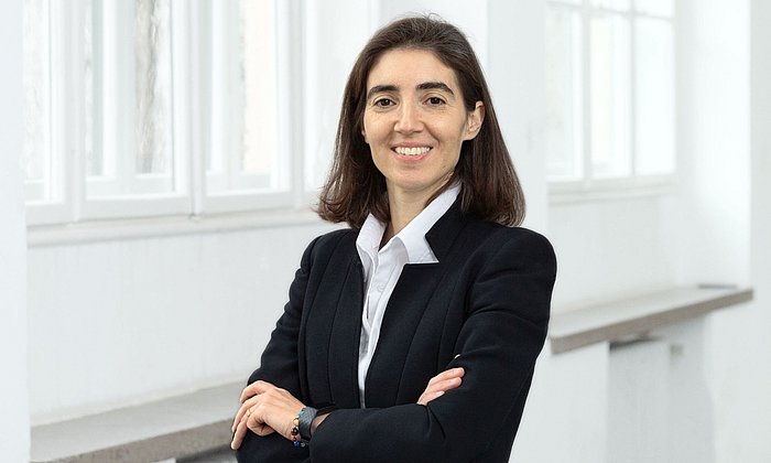 Photo of Prof. Dr. Chiara Manfletti in a black jacket in front of a white window front