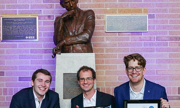 TUM researchers (l-r) Fabian Steiner, Georg Böcherer, and Patrick Schulte with the statue of Claude Shannon, father of information theory. (Image: Denise Panyik-Dale/Alcatel-Lucent)