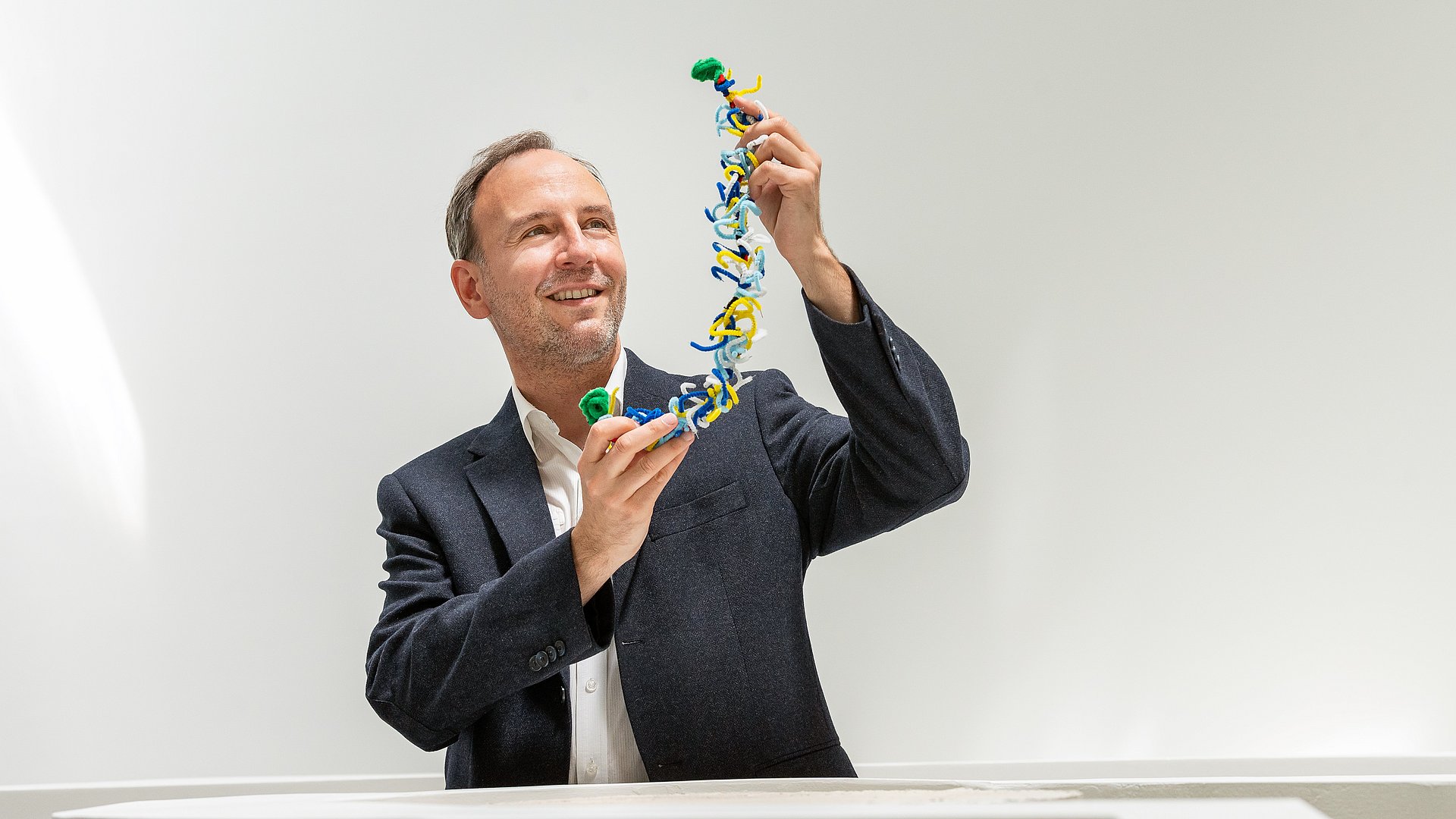 Oliver Lieleg, Professor of Biomechanics at the Technical University of Munich, with a model of a mucin. 