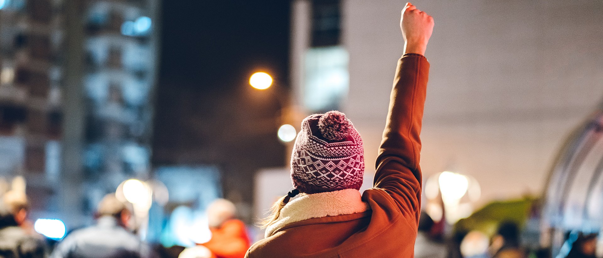 A woman raises her fist during a demonstration.