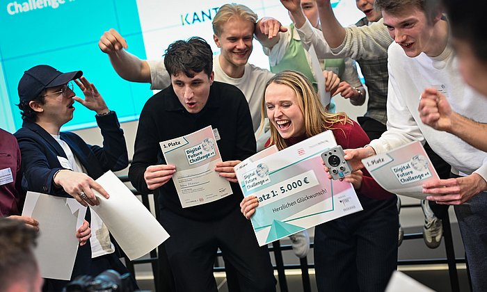  The jubilant members of the "EduPin" team with the certificates for their first place in the Digital Future Challenge and a prototype of the pin